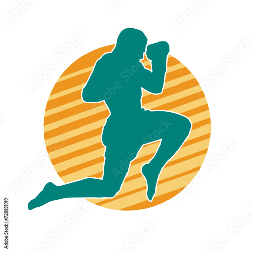 Silhouette of a kickboxer athlete in action pose. Silhouette of a sporty man doing kicking pose.