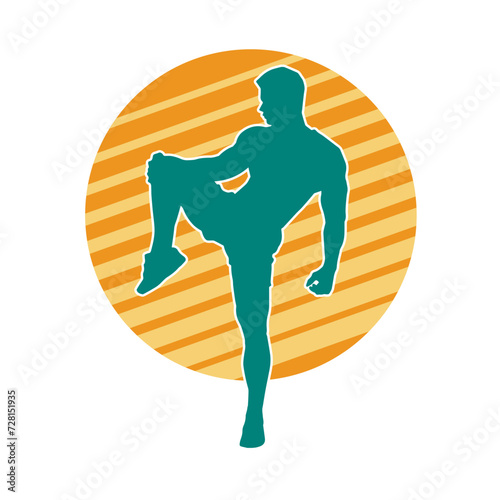 Silhouette of a sporty male in action pose at the gym. Silhouette of a slim man in aerobics workout pose.