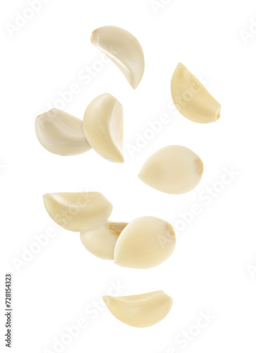 Fresh garlic cloves falling on white background