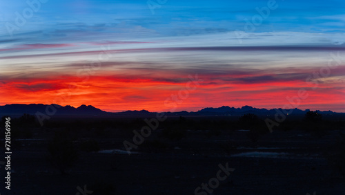 Arizona sky over silhouette of geological formation in the desert 