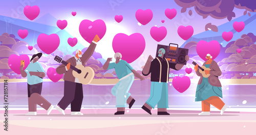 mix race senior people in love with bass clipping blaster recorder dancing and singing grandparents having fun active old age valentines day