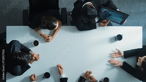 Top down aerial view of professional business people writing and sharing marketing idea on sticky note. Group of diverse executive manager working together or brainstorming strategy. Directorate.