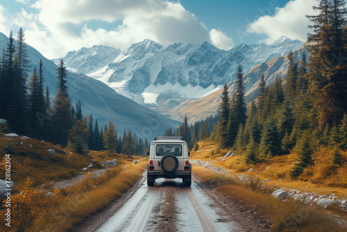 SUV on a snowy trail near a mountain lake. © P