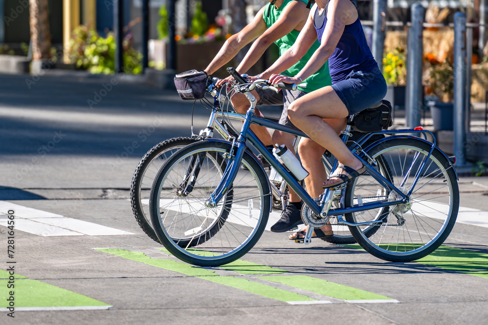 Two women amateur cyclists ride bicycles to maintain their figure and lose weight and maintain a healthy lifestyle pedaling bikes