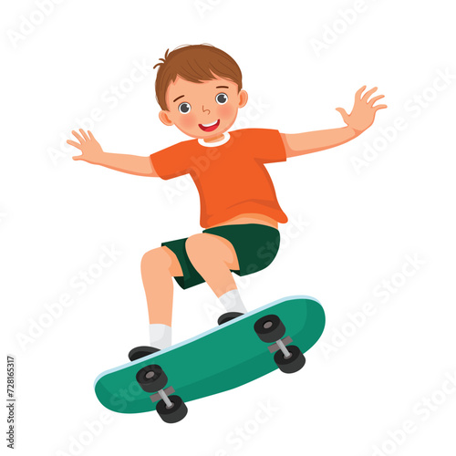 Cute little boy playing skateboard 