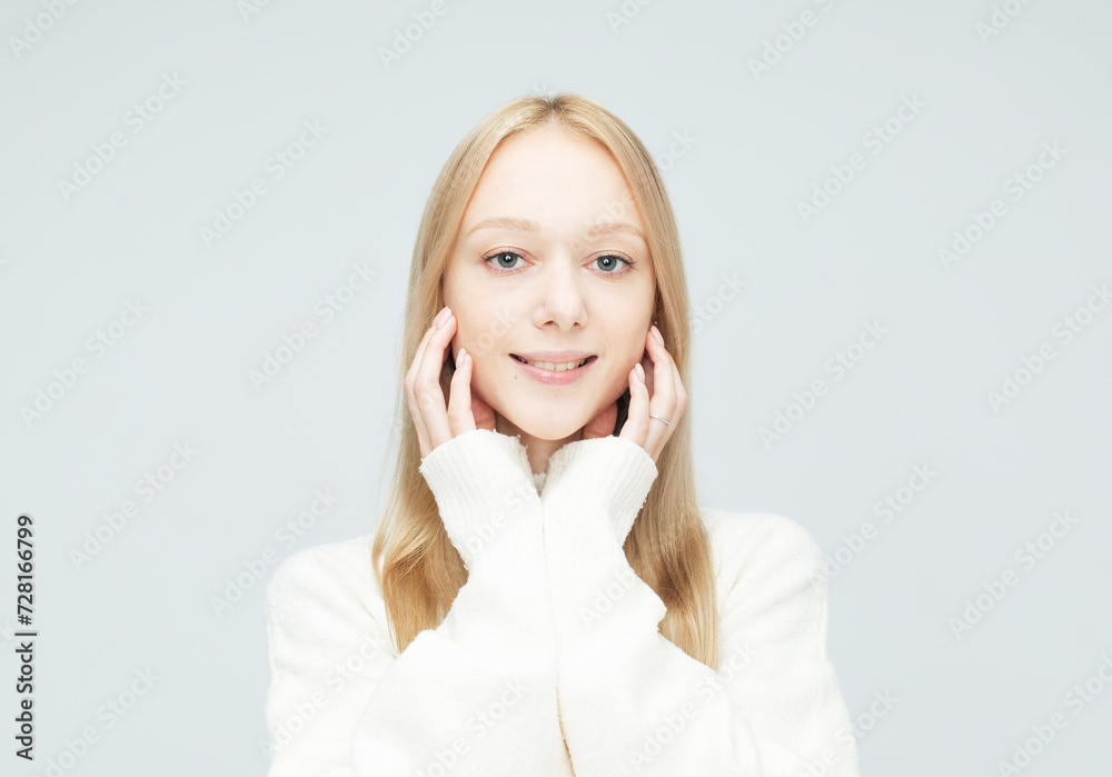 cheerful young woman with blond hair smiling isolated over light grey color background cheerful young woman with blond hair smiling isolated over light grey color background