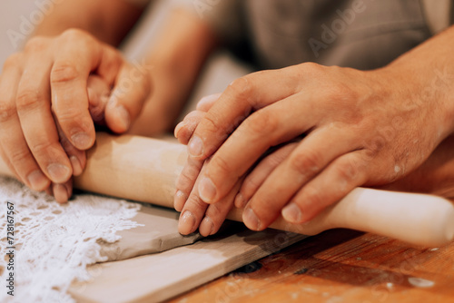 A young couple is engaged in creativity in a pottery workshop. Hands close up.
