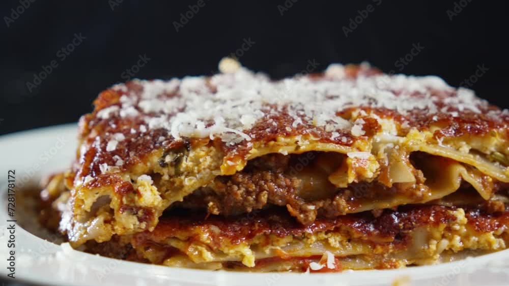 A slider shot capturing a freshly served piece of lasagna, showcasing its layers of flavor in exquisite detail. A slider shot capturing a freshly served piece of lasagna, showcasing its layers of flavor in exquisite detail.
