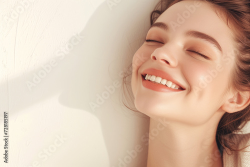 a woman smiling over a white background
