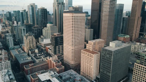 Aerial orbital parallax around beige and modern sleek silver downtown skyline buildings of Seattle Washington photo