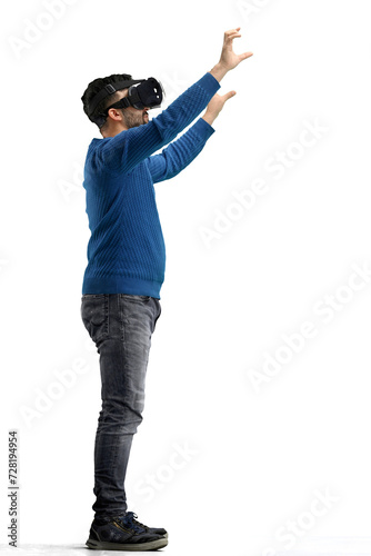 Man, full-length, on a white background, wearing VR glasses