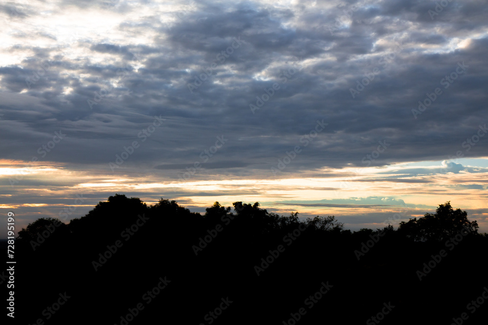 Panoramic cloudscape with the sun rays radiating from behind the cloud.Phnom Bakheng sunset view Angkor Wat, Siem Reap, Cambodia Panoramic cloudscape with the sun rays radiating from behind the cloud.Phnom Bakheng sunset view Angkor Wat, Siem Reap, Cambodia