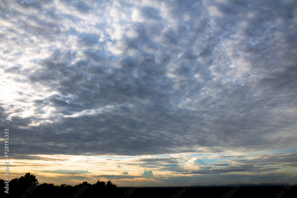 Panoramic cloudscape with the sun rays radiating from behind the cloud.Phnom Bakheng sunset view Angkor Wat, Siem Reap, Cambodia