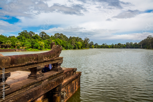 Reflections of the jungle over the broad moat of the ancient temple of Angkor Wat, in Cambodia