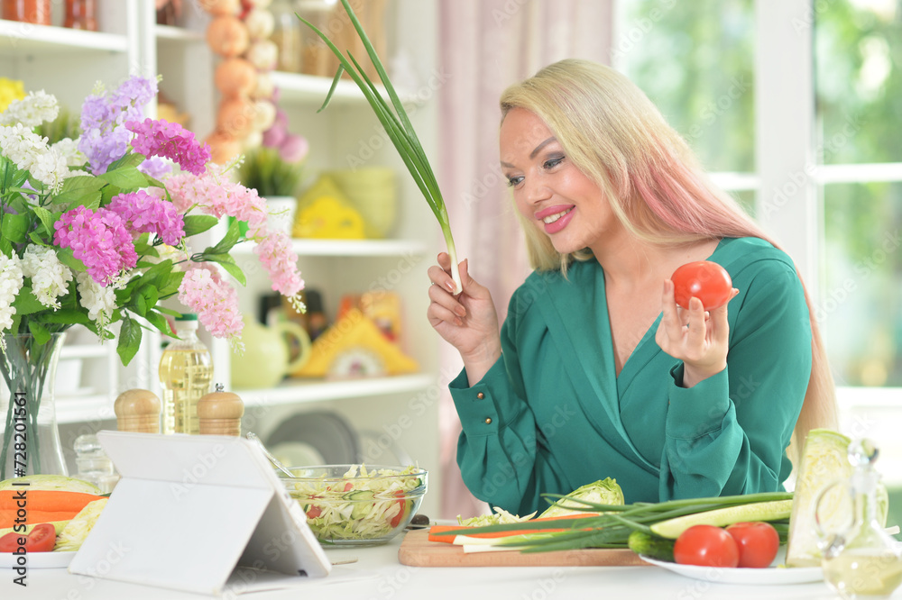 Young woman cooking healthy food in kitchen Young woman cooking healthy food in kitchen