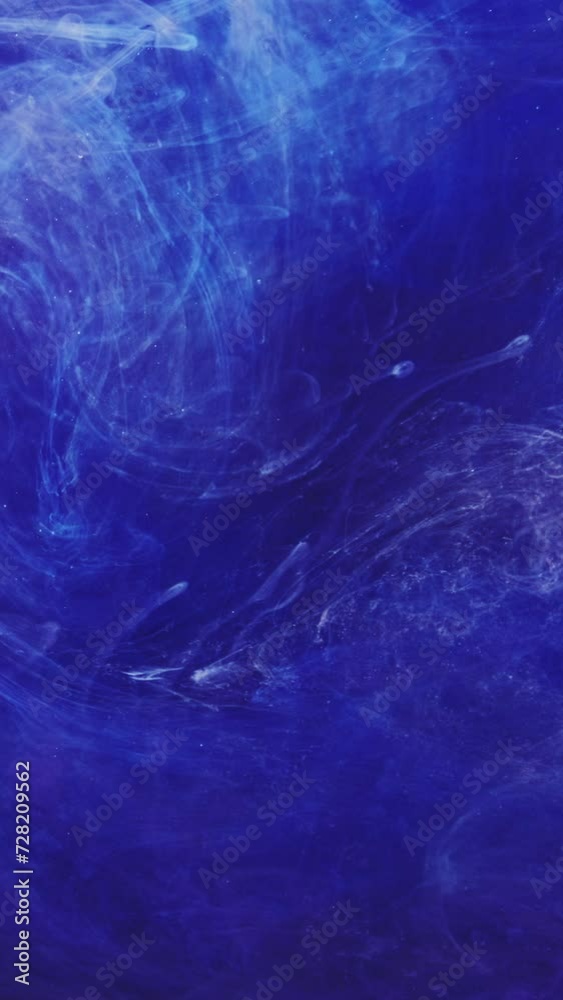 Vertical video. Color fume background. Mysterious air. Blue white ink blend flow effect smooth texture abstract vibrant swirls spreading in water hypnotic art. Vertical video. Color fume background. Mysterious air. Blue white ink blend flow effect smooth texture abstract vibrant swirls spreading in water hypnotic art.