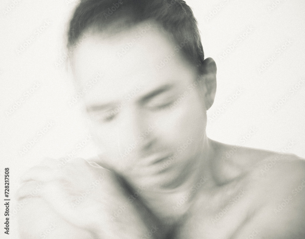 A mature man is hugging himself with despair. A mature man is hugging himself with despair.