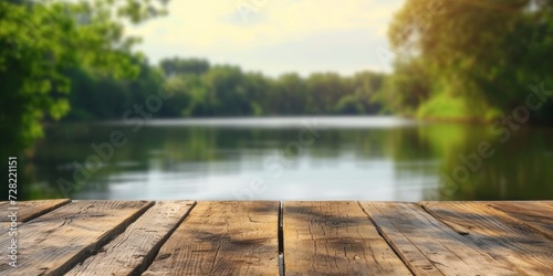 Calm sunny evening in nature with view to lake, river water and forest, park trees. Table top with copy space for product advertising