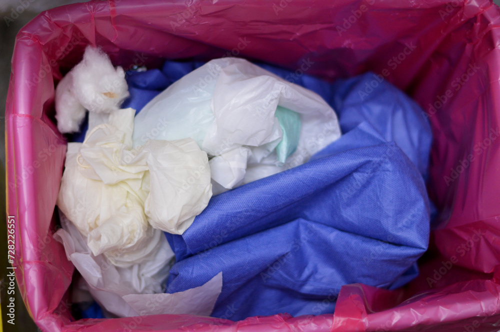 Biohazardous medical waste placed inside red bag for disposal, used specimen swabs, used glucose