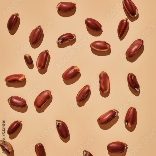 Multiple roasted coffee beans artistically arranged on a beige background with even lighting