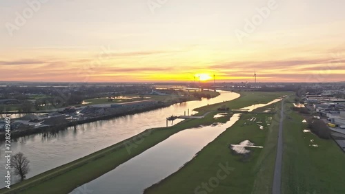 Wallpaper Mural Aerial sunset drone shot passing over industrial area with impressive windturbines and bridge on the horizon.  The colors in the sky are impressive and colorfull Torontodigital.ca