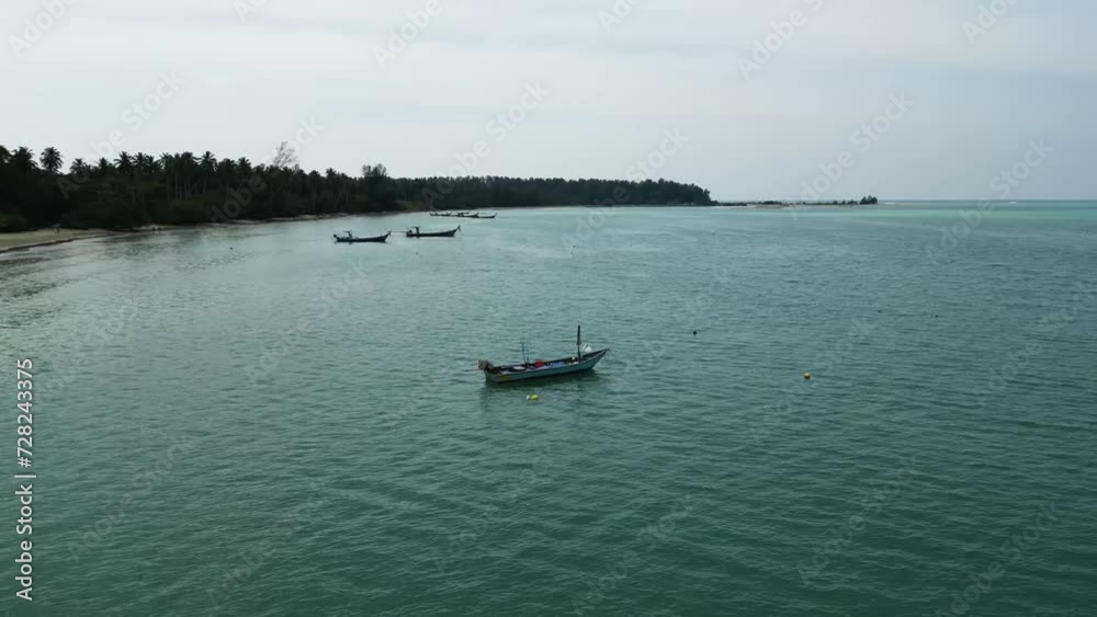 Long tail boats Ruea Hang Yao floating on the shore of Coconut beach Kaoh Lak in Thailand, Aerial flyover shot Long tail boats Ruea Hang Yao floating on the shore of Coconut beach Kaoh Lak in Thailand, Aerial flyover shot
