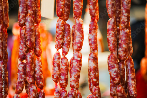 a row of Taiwanese sausages hanging on a stall