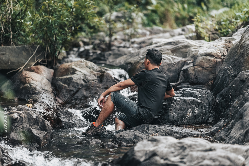 Hikers relax in the stream flowing from the waterfall. hiking concept. Hikers relax in the stream flowing from the waterfall. hiking concept.