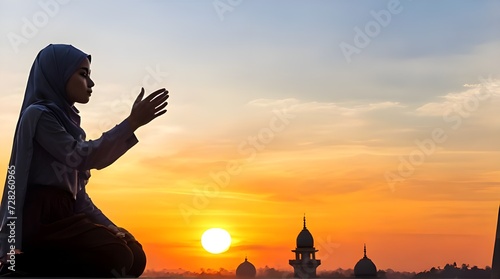 Silhouette Young muslim woman hijab honesty pray to God on sunset panoramic mosque background, concept for eid mubarak  life and spiritual of islam girl fasting in ramadan  Indonesian civilian people photo