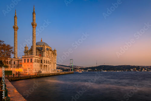 Picturesque cityscape with the Bosphorus Strait and the Grand Mecidiye Mosque Ortakoy Mosque and the Bosphorus Bridge Istanbul, Turkey at sunset