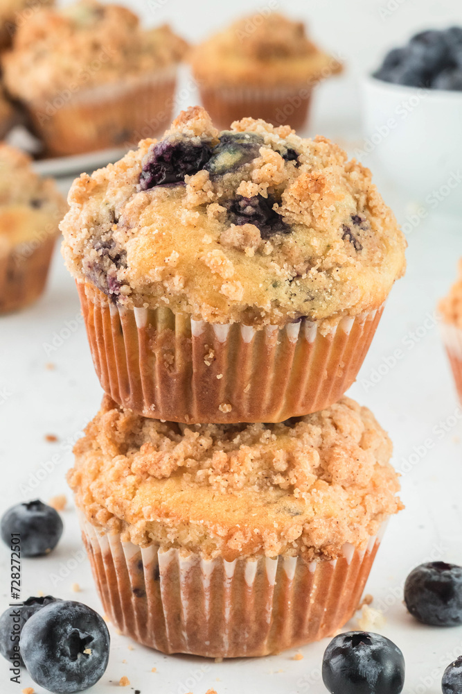 A double stack of blueberry muffins with a streusel topping
