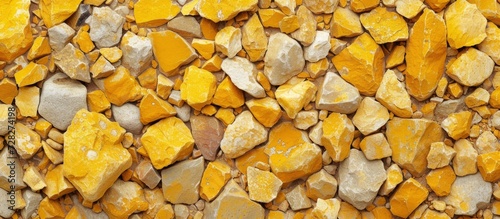 Eye-Catching Yellow Concrete Rocks Texture Background: Small Rocks Shine Bright in a Vibrant Yellow Concrete Texture Background.
