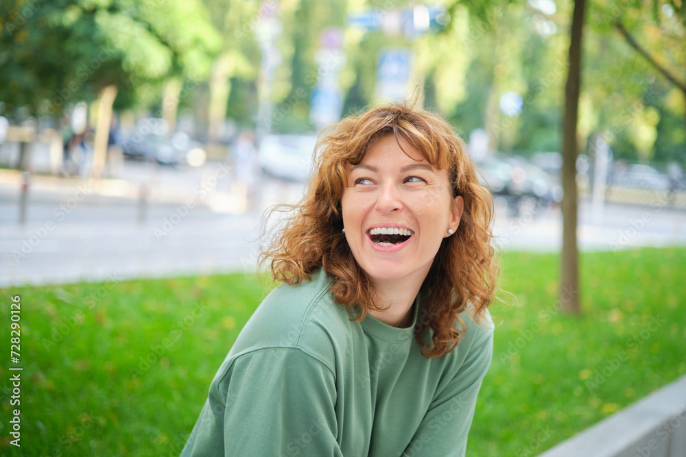 Face, smile and portrait of a woman happy in a park in summer for beauty, excited and confident in nature. garden and female person or model outdoor with freedom, happiness, style. High quality photo