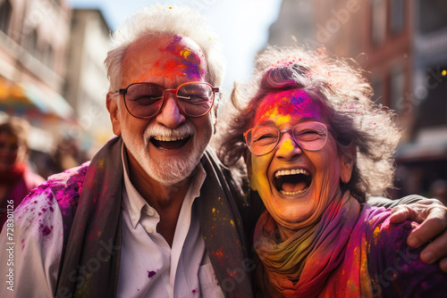 Senior couple laughing with Holi colors on city street © Photocreo Bednarek