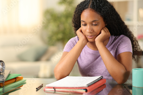 Black student memorizing notes at home photo