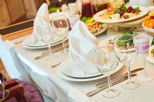 The setting of the festive table. Food and dishes. Festive glasses for drinks. © Fotoproff