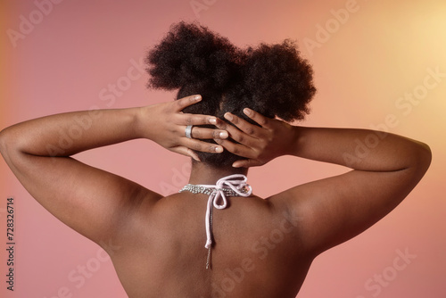 Woman with head in hands standing against gradient background photo