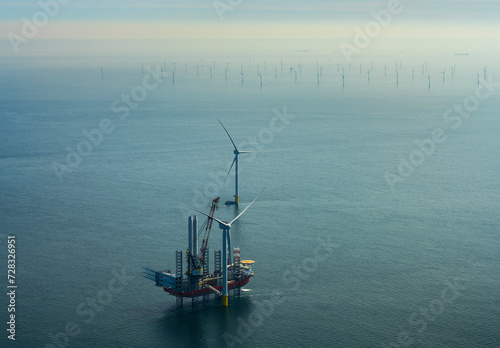 Netherlands, North Holland, IJmuiden, Aerial view of wind turbine installation vessel at offshore wind farm photo