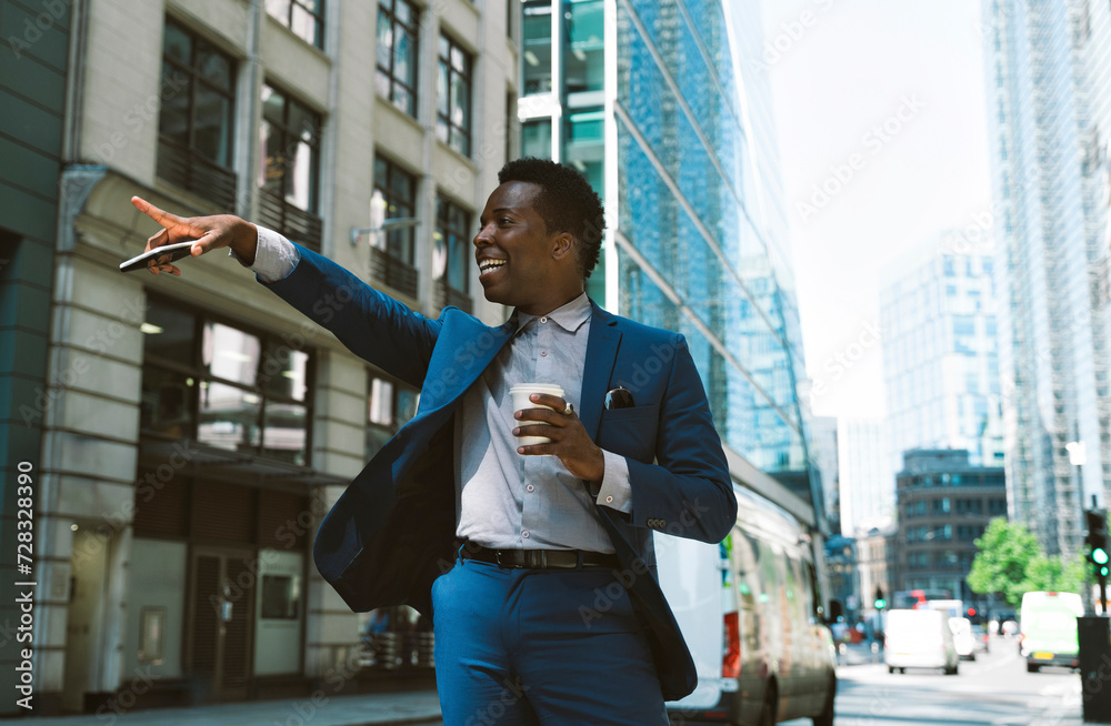 Happy businessman gesturing and standing with coffee cup on street