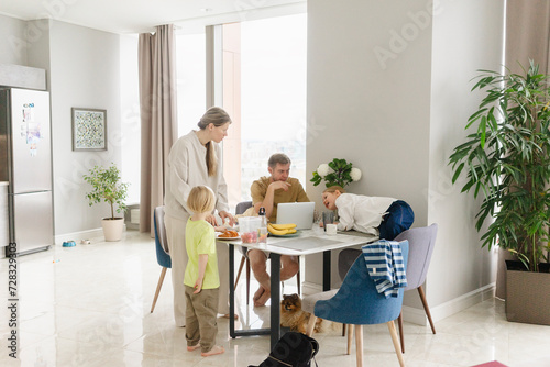 Family having breakfast at dining table photo