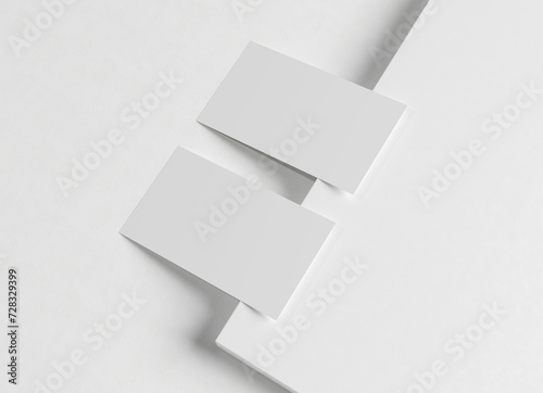 Two white business card Mockup. Textured calling card template on a blank surface. 3D rendering © sdecoret