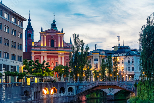 Slovenia, Ljubljana, Triple Bridge at dusk with Franciscan Church of Annunciation in background photo