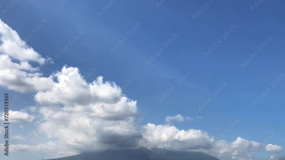 Time lapse of blue sky with white clouds over Salak mountain. Salak mountain view in a sunny morning. Beautiful background footage.