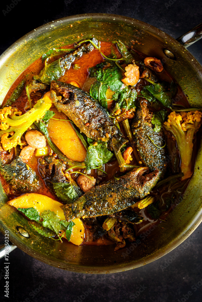 Koi Fish Curry with Seasonal Vegetables cooked in a traditional Bengali style Koi Fish Curry with Seasonal Vegetables cooked in a traditional Bengali style