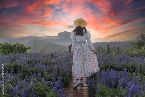 Asian woman relax and freedom in beautiful blooming cosmos flower garden. Travel happy and Lifestyle Concept. © tonjung