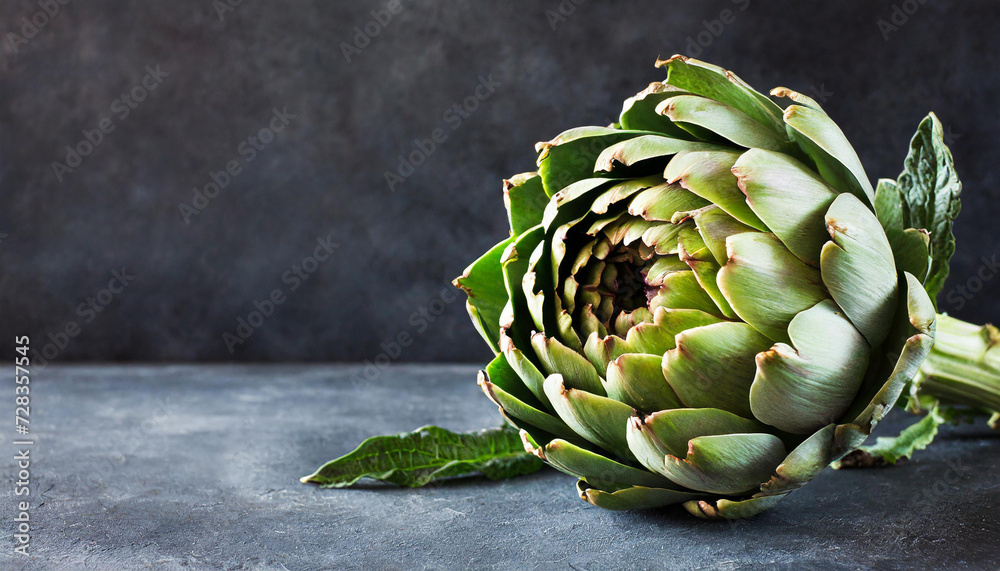 Fototapeta premium Artichoke close-up. Dark background, copyspace