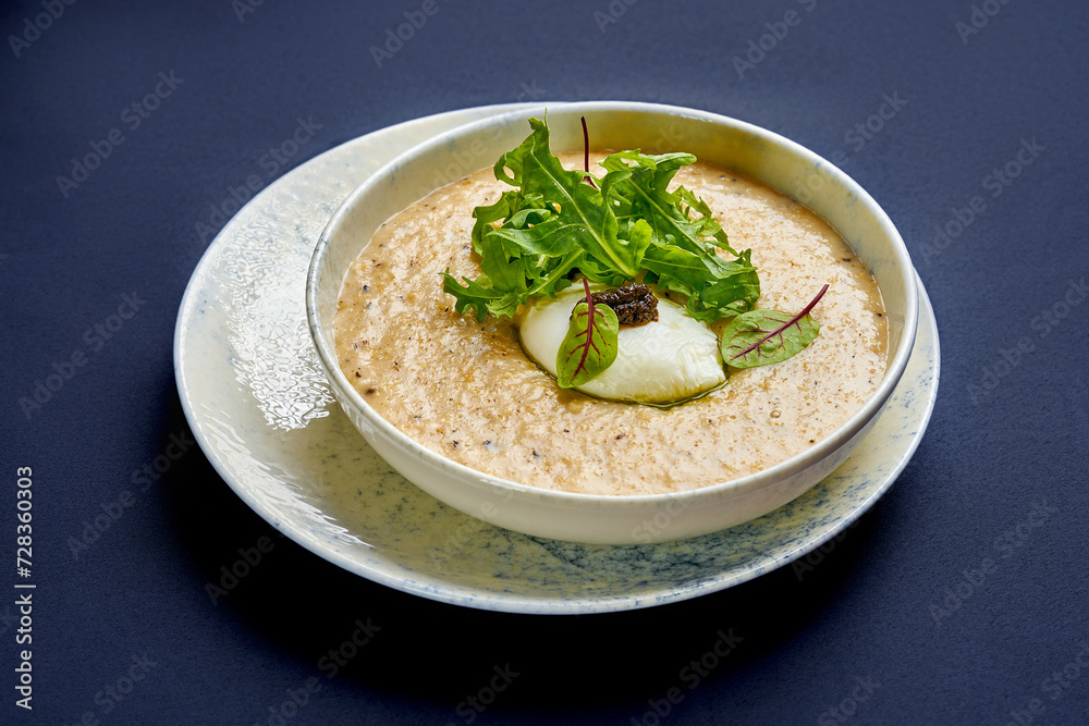 Oat porridge with truffle paste and poached egg. Breakfast oatmeal Oat porridge with truffle paste and poached egg. Breakfast oatmeal
