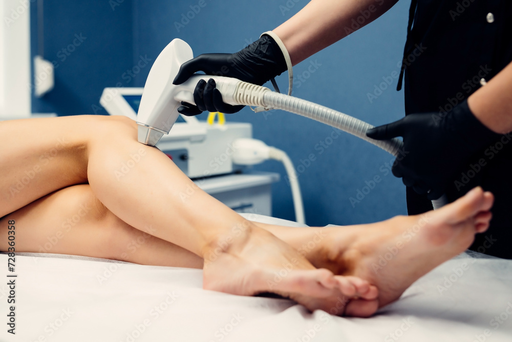 Hair removal cosmetology procedure from a therapist at cosmetic beauty spa clinic. Laser epilation and cosmetology.