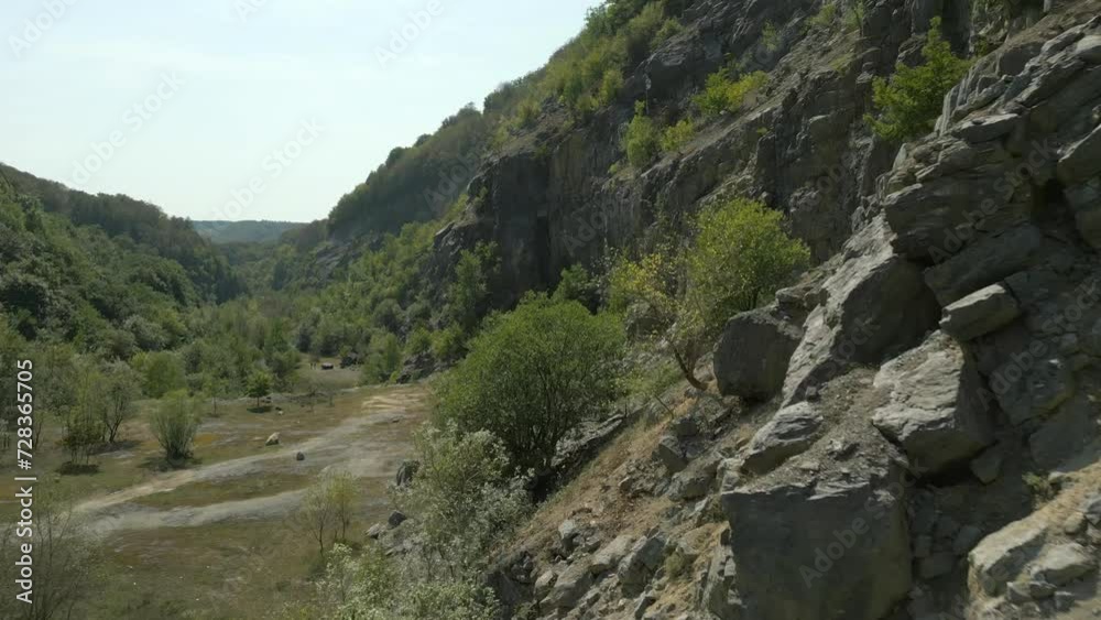 Aerial fly over old rock quarry valley on summer day in Slovakia, Europe Aerial fly over old rock quarry valley on summer day in Slovakia, Europe