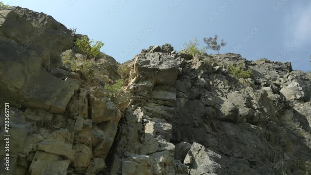 Aerial elevating low angle shot of rock cliff on summer day in Europe Aerial elevating low angle shot of rock cliff on summer day in Europe